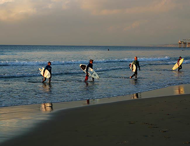 <b>Surfers Done</b><br>Another shot from our afternoon at La Jolla Shores. I haven't had time to go through my shots and actually work on them yet. I am hoping sometime tomorrow afternoon or Thursday but who knows. This is actually taken with my Macro lens. I just liked the shot of four of them lined up and had just changed lenses so snapped a photo anyway. Btw, I just bought a remote switch so I can attempt some of the extraordinary night shots I've been seeing. More on this later.